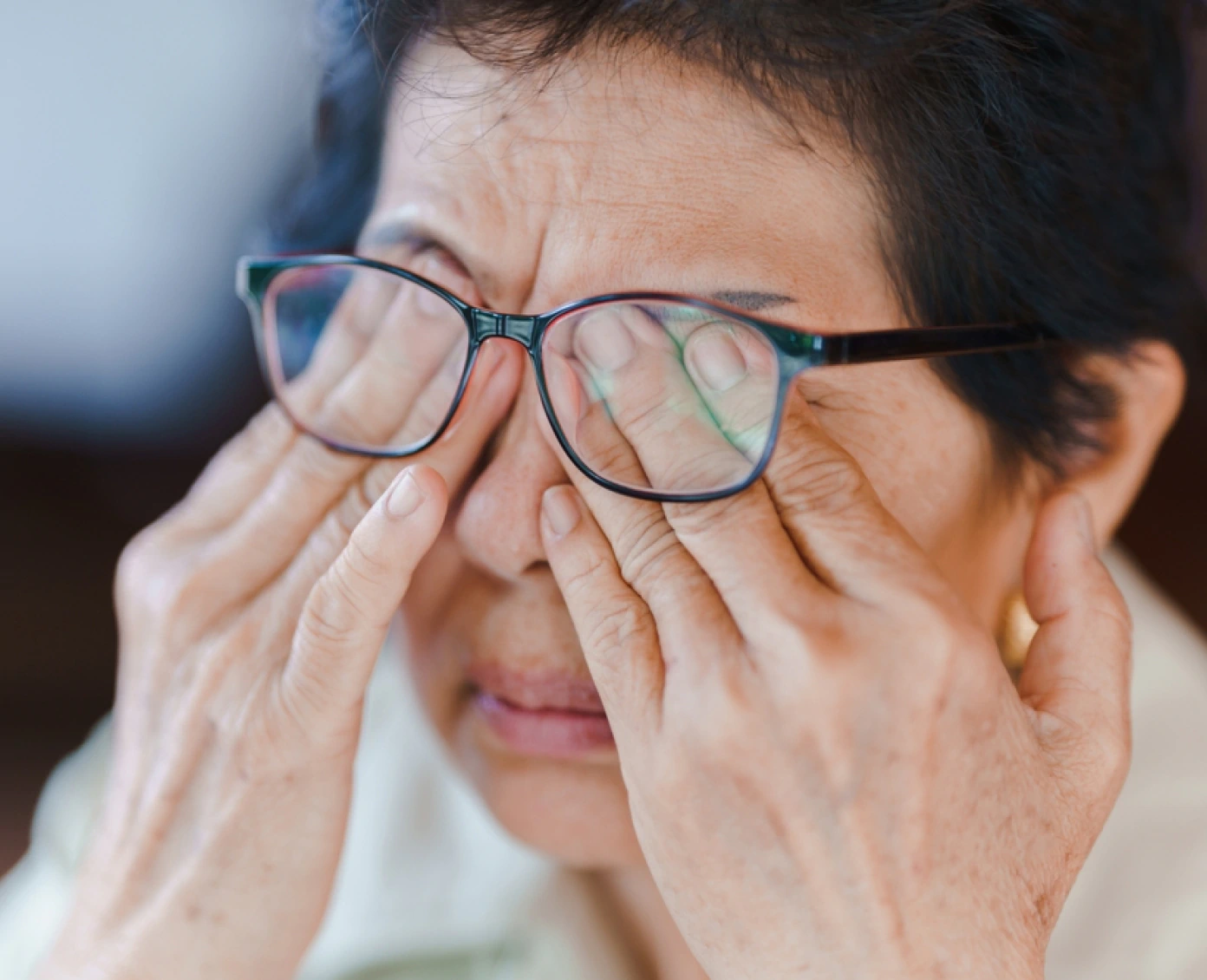 Woman rubbing eyes